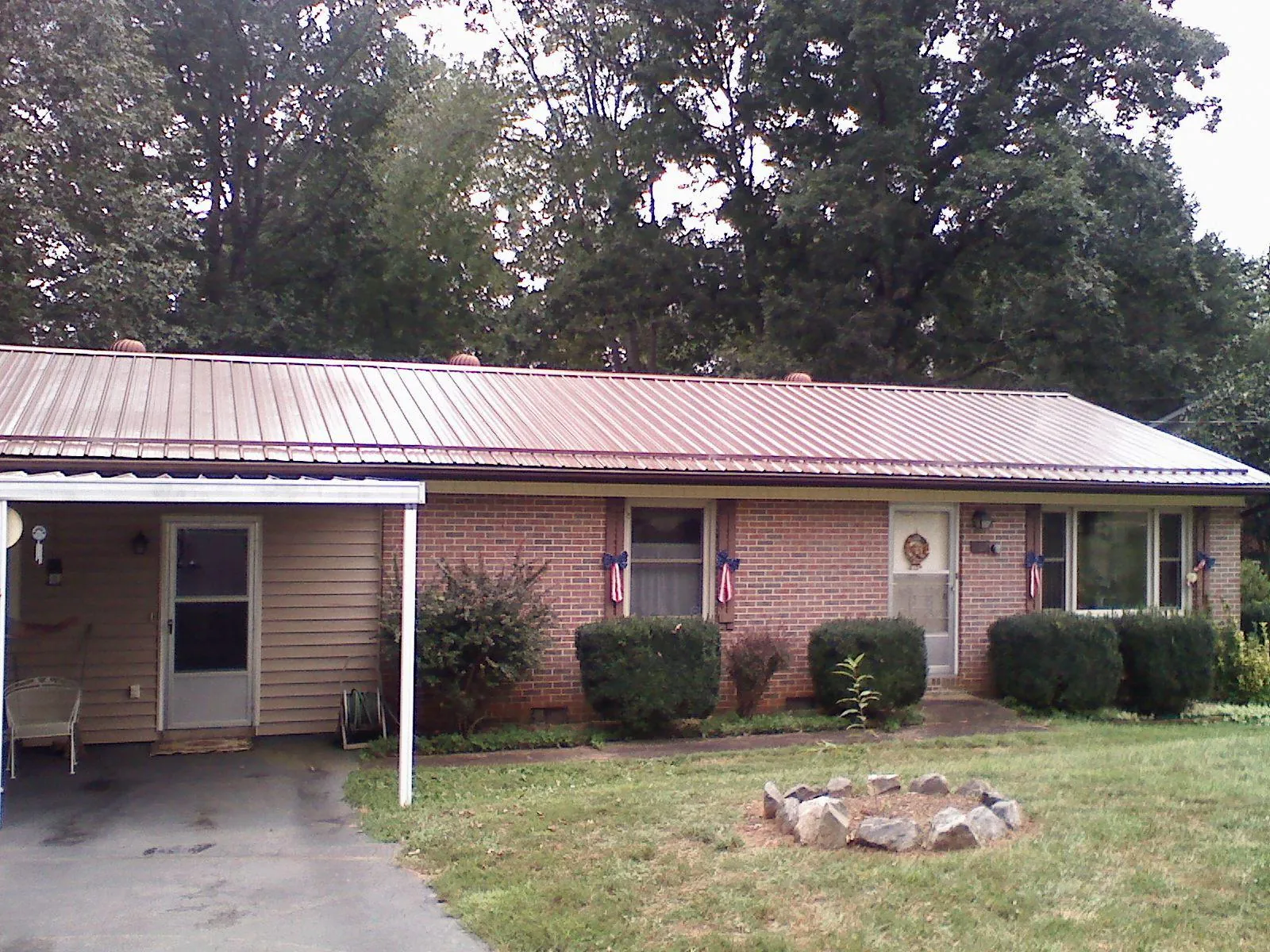 Bronze metal roof and carport on a brick ranch home — Roof Repair work by our crew in Mosheim