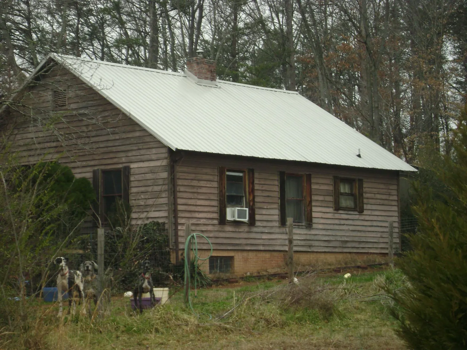 White metal roof on an old wood sided farmhouse, from a Metal Roof Installation job in Mosheim